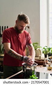 Young Adult Man Cooking Pasta