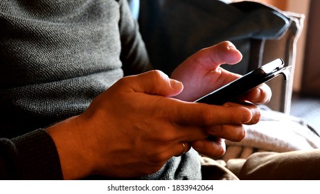 Young adult man hands tap phone screen. User typing by smartphone. Technology and communication concept - Shutterstock ID 1833942064