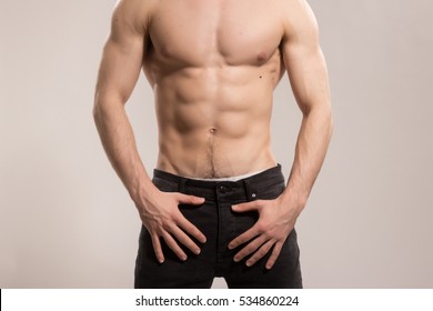 Young Adult Man, Strong Muscular, Upper Body Shot. Wearing Jeans, No Head, Face Visible, Unrecognizable Person.