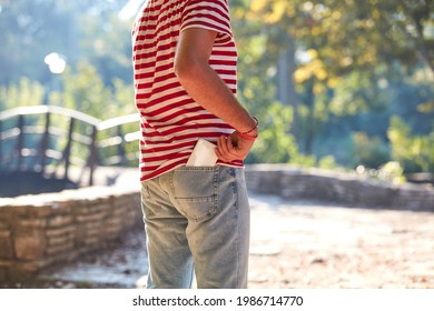 Young adult man using modern smartphone in the park.