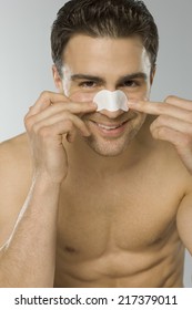 Young Adult Man Using Nasal Strip, Portrait