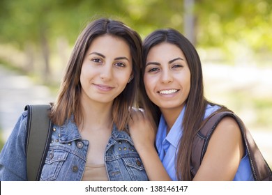 Young Adult Mixed Race Twin Sisters Portrait Wearing Backpacks Outside.