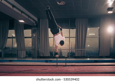 Young Adult Muscular Man, One One Hand Cartwheel, Large Hall.