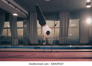 Young Adult Muscular Man, One One Hand Cartwheel, Large Hall.