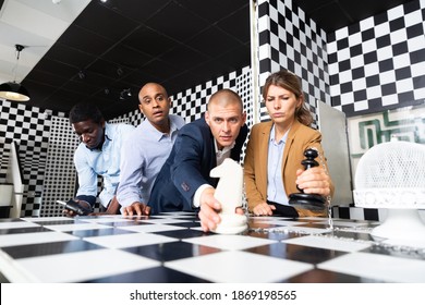 Young Adult People Trying To Solve Puzzles To Get Out Of Escape Room