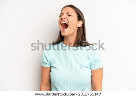young adult pretty woman screaming furiously, shouting aggressively, looking stressed and angry