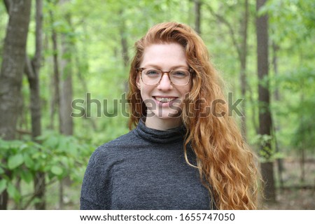 Young adult profile picture with red hair.