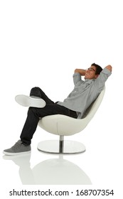 Young adult relaxing on chair with hands behind head looking up isolated on white
