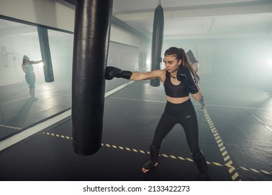 Young Adult Sexy Woman Doing Back Leg High Kick During Kickboxing.