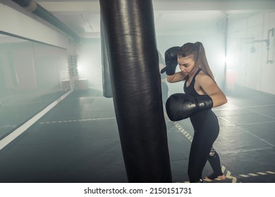 Young Adult Sexy Woman Doing Back Leg High Kick During Kickboxing.