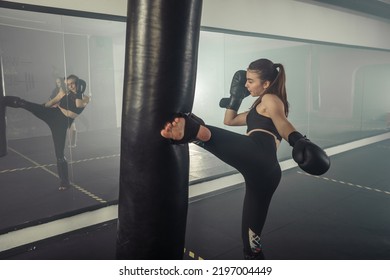 Young Adult Sexy Woman Doing Back Leg High Kick During Kickboxing.