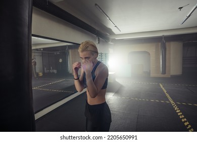 Young Adult Sexy Woman Doing Back Leg High Kick During Kickboxing.