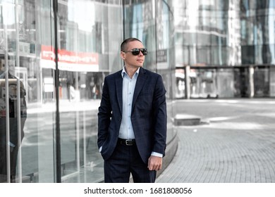 Young adult successful man in a suit standing at the street - Shutterstock ID 1681808056