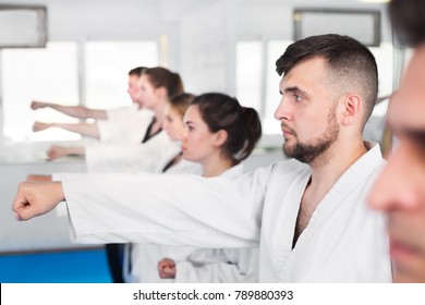 Young Adult Trainees Practicing Of New Maneuvers At Karate Class 