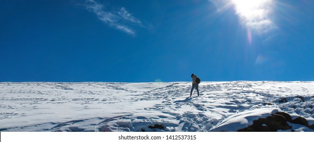 A young adult trekking across snowy landscape of Himalayas. Photo is taken during the Chandrashila summit at Uttarakhand, India. - Shutterstock ID 1412537315