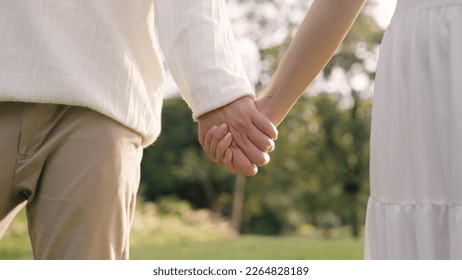 Young adult two fiance asia lover man and woman happy begin couple date life flirt sweet care touch. Asian people bride groom fall in love relax hold hand swear with trust hope on newlywed family day. - Shutterstock ID 2264828189