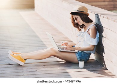 Young Adult Using Laptop Outdoors