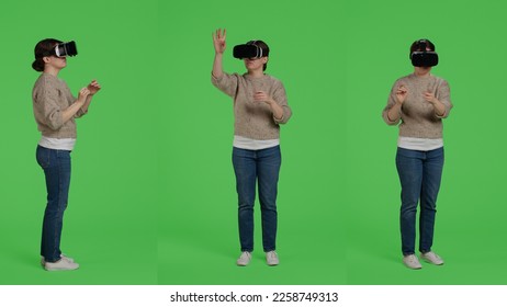 Young adult using vr glasses over full body greenscreen backdrop, having fun with virtual reality headset and artificial intelligence. Female model enjoying modern 3d goggles in studio. - Powered by Shutterstock