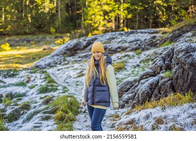 Young adult woman alone slowly walking after snowfall. Peaceful atmosphere in amazing awesome winter day. Enjoying fresh air in snowy forest trail