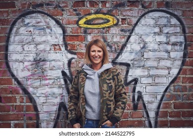 Young Adult Woman With Angel Wing On The Wall