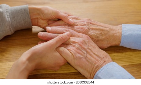 Young Adult Woman Daughter Granddaughter Holding Elderly Father, Giving Love Care To Senior People, Helping Older Parents And Grandparents