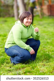 Young Adult Woman With Disability Enjoying Nature In Spring Garden