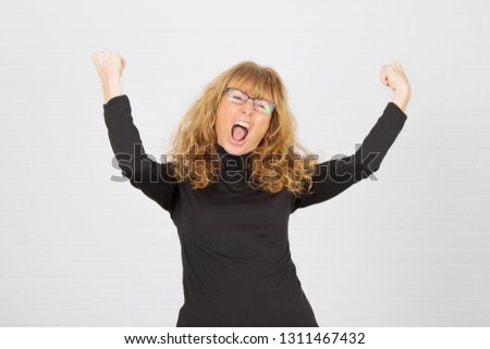 young adult woman with expression of success and celebration