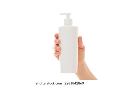 Young adult woman hand holding big plastic pump bottle isolated on white background. Care about clean and soft body skin. Daily beauty product. Closeup. Front view. - Powered by Shutterstock
