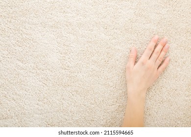 Young adult woman hand touching beige new fluffy home carpet. Closeup. Checking softness. Empty place for text.  - Powered by Shutterstock