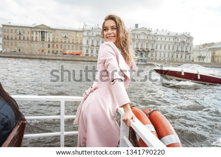 Young adult woman on excursion at the Saint Petersburg's river Neva and Fontanka. Motor ship walks and excursion in SPB