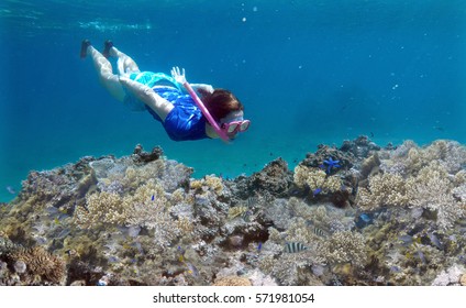 Young  Adult Woman Snorkeling Underwater Over A Coral Reef In A Tropical Resort On Vanua Levu Island, Fiji. Real People Copy Space