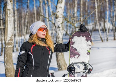 Young Adult Woman Snowboarder Holding Board In Heand In Snow Winter