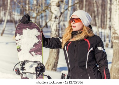 Young Adult Woman Snowboarder Holding Board In Heand In Snow Winter