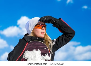 Young Adult Woman Snowboarder Holding Board In Heand In Snow Winter