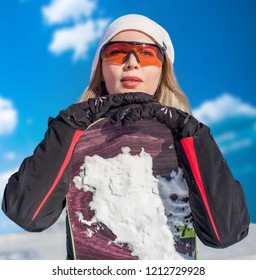 Young Adult Woman Snowboarder Holding Board In Heand In Snow Winter