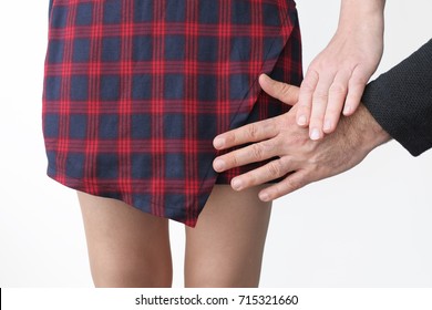 Young Adult Woman Wearing Sexy Short Skirt Holding Male Hand Refusing An Unwanted And Unwelcome Sexual Advance.Sexual Harassment Concept. Isolated On White Background. Unrecognizable People.Copy Space