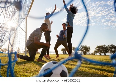 Young Adults Cheering A Scored Goal At Football Game