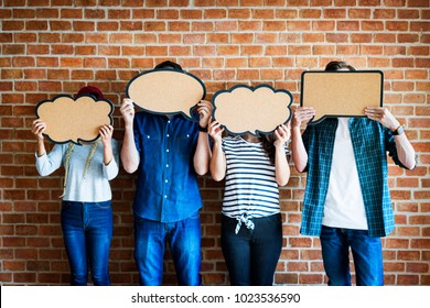 Young adults holding up copyspace placard thought bubbles - Shutterstock ID 1023536590