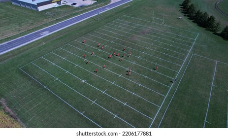 Young Adults Playing Flag Football On A Sunny Day.