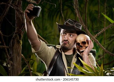 Young Adventurer Taking A Self Portrait With A Skull In The Jungle.