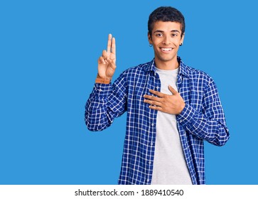 Young african amercian man wearing casual clothes smiling swearing with hand on chest and fingers up, making a loyalty promise oath 