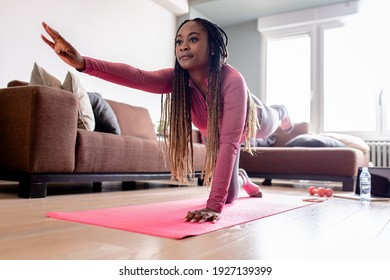 Young African America Woman At Home Doing Exercise.