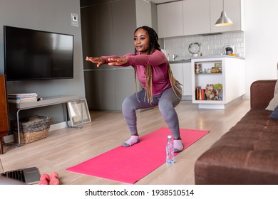 Young African America Woman At Home Doing Exercise.