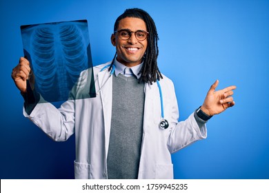 Young African American Afro Doctor Man With Dreadlocks Holding Chest Lung Xray Very Happy Pointing With Hand And Finger To The Side