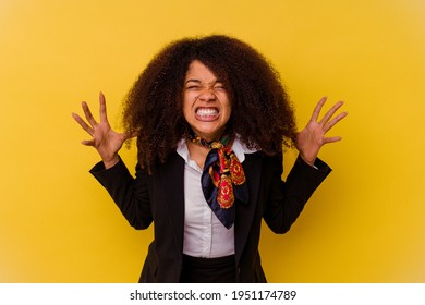 Young African American Air Hostess Isolated On Yellow Background Screaming With Rage.