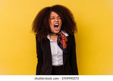 Young African American Air Hostess Isolated On Yellow Background Screaming Very Angry And Aggressive.