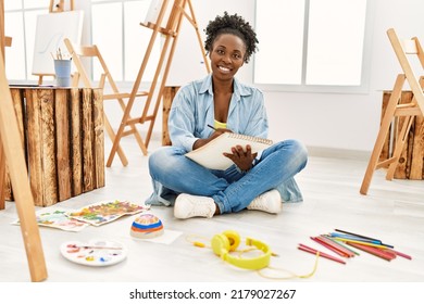 Young african american artist woman smiling happy drawing at art studio.