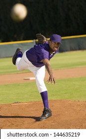 Young African American baseball pitcher throwing the ball