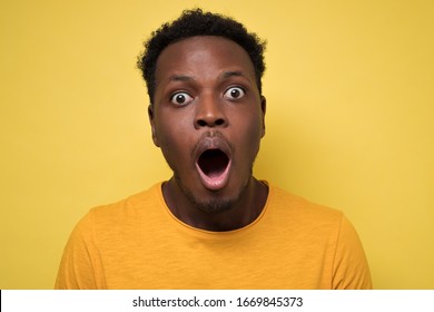 Young African American Black Man Surprised Face Expression. Studio Shot On Yellow Wall.