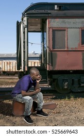 Young African American Black Man Going On Vacation Sitting On A Vintage Guitar Case